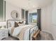 Charming bedroom featuring a large window, and a metal bed frame with decorative pillows at 1811 Spring Shower Cir, Kissimmee, FL 34744
