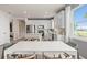 Open-concept kitchen with white cabinets, stainless steel appliances, and an island, flowing into the dining area at 1811 Spring Shower Cir, Kissimmee, FL 34744