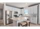 Bright kitchen featuring white cabinets, stainless steel appliances, and a marble-topped island with seating at 1811 Spring Shower Cir, Kissimmee, FL 34744