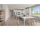 Bright, open kitchen with white cabinetry, stainless steel appliances, and an island, adjoining a dining area at 1811 Spring Shower Cir, Kissimmee, FL 34744