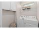 Functional laundry room equipped with a washer, dryer, and built-in storage at 1811 Spring Shower Cir, Kissimmee, FL 34744