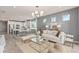 Open-concept living space with a view of the kitchen and dining area, featuring modern furnishings and natural light at 1811 Spring Shower Cir, Kissimmee, FL 34744