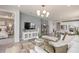 Stylish living room showcasing an open floor plan with modern furnishings and seamless access to the kitchen at 1811 Spring Shower Cir, Kissimmee, FL 34744