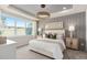 Stylish bedroom featuring a decorative tray ceiling, wood accent wall, and a large window at 1811 Spring Shower Cir, Kissimmee, FL 34744