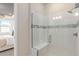 Glass enclosed shower with white tiled walls, a shower seat, and modern fixtures at 1811 Spring Shower Cir, Kissimmee, FL 34744