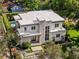 Aerial view showcases a modern home, meticulously landscaped yard, and sparkling pool at 1820 Englewood Rd, Winter Park, FL 32789