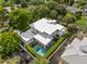 Aerial view of a property with a private pool, surrounded by lush green landscaping at 1820 Englewood Rd, Winter Park, FL 32789