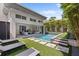 Luxury backyard with a modern pool, sun loungers, and an open-concept living area at 1820 Englewood Rd, Winter Park, FL 32789