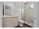 Bright bathroom featuring a walk-in shower with tile surround, sleek vanity, and a toilet at 1820 Englewood Rd, Winter Park, FL 32789