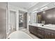 Modern bathroom featuring double vanities, a luxurious soaking tub, and a glass-enclosed shower at 1820 Englewood Rd, Winter Park, FL 32789