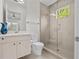 Modern bathroom with glass shower, sink vanity, and tiled floors at 1820 Englewood Rd, Winter Park, FL 32789