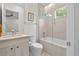 Bright bathroom featuring a shower and tub combination with tile surround, sleek vanity, and a toilet at 1820 Englewood Rd, Winter Park, FL 32789