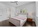 Bright bedroom with hardwood floors, a queen bed, and ensuite bathroom access at 1820 Englewood Rd, Winter Park, FL 32789