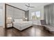 Modern bedroom with a gray upholstered headboard, chaise lounge, hardwood floors and recessed lighting at 1820 Englewood Rd, Winter Park, FL 32789