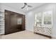 Bright bedroom featuring a stylish murphy bed, designer dresser, and natural light at 1820 Englewood Rd, Winter Park, FL 32789
