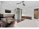 Modern bedroom featuring a sitting area, flat-screen television, hardwood floors and recessed lighting at 1820 Englewood Rd, Winter Park, FL 32789