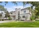 Attractive modern two-story house with white stucco, stone accents, and lush green lawn at 1820 Englewood Rd, Winter Park, FL 32789