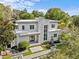 Modern home with striking architectural details, a stone facade, and professional landscaping at 1820 Englewood Rd, Winter Park, FL 32789