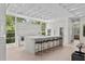 Open kitchen with oversized center island, modern appliances, and abundant natural light from the large windows at 1820 Englewood Rd, Winter Park, FL 32789