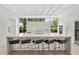 Bright, modern kitchen with a large island, counter seating, and a huge window overlooking the landscaped yard at 1820 Englewood Rd, Winter Park, FL 32789