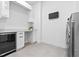 Bright laundry room with sleek cabinetry, counter space, and modern appliances at 1820 Englewood Rd, Winter Park, FL 32789