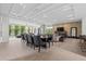 Open-concept living room with tile floors, fireplace, and sliding glass doors to backyard at 1820 Englewood Rd, Winter Park, FL 32789