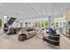 Bright living room showcasing modern furnishings, tiled floors, and sliding glass doors to the outside at 1820 Englewood Rd, Winter Park, FL 32789