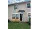 Backyard exterior featuring a door entry and patio area at 2018 Cypress Bay Blvd, Kissimmee, FL 34743