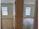 Hallway view of two bedrooms with neutral carpet and natural light at 2018 Cypress Bay Blvd, Kissimmee, FL 34743