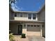 Charming townhome with a one-car garage and neutral exterior paint at 2018 Cypress Bay Blvd, Kissimmee, FL 34743
