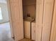 A laundry closet that features a washing machine, dryer and shelving at 2018 Cypress Bay Blvd, Kissimmee, FL 34743