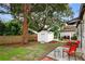 Backyard with mature trees, patio and privacy fence, complete with shed and seating, perfect for enjoying the outdoors at 2021 University Dr, Orlando, FL 32804