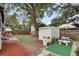 A backyard featuring a shed, mature trees, patio and privacy fence, complete with seating, perfect for relaxation at 2021 University Dr, Orlando, FL 32804