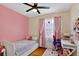 Pink bedroom featuring hardwood floors and a large sunny window at 2021 University Dr, Orlando, FL 32804