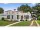 Charming home featuring stucco walls, a red roof, landscaped yard, and a quaint front entrance at 2021 University Dr, Orlando, FL 32804