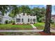 A charming home with a stucco exterior, red trim, inviting landscaping, and a tidy front yard at 2021 University Dr, Orlando, FL 32804