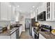 Well-lit kitchen featuring granite counters, stainless appliances and white cabinetry at 2021 University Dr, Orlando, FL 32804