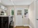 Functional laundry area featuring modern appliances, storage shelves, natural light, and backyard access at 2021 University Dr, Orlando, FL 32804