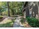 Tree covered walkway leading to a back door at 209 Villa Di Este Ter # 205, Lake Mary, FL 32746