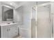Clean bathroom featuring a large mirror, bathtub, and glass-enclosed shower at 209 Villa Di Este Ter # 205, Lake Mary, FL 32746