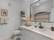 Stylish bathroom features a modern vanity, a large mirror, and neutral decor at 209 Villa Di Este Ter # 205, Lake Mary, FL 32746