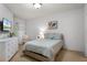 Bright bedroom featuring a comfortable bed, soft lighting, and modern decor at 209 Villa Di Este Ter # 205, Lake Mary, FL 32746