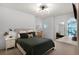 Serene bedroom with a dark green bed, ample natural light, and neutral tones at 209 Villa Di Este Ter # 205, Lake Mary, FL 32746