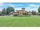 Stately community clubhouse on a vast green lawn with a fountain feature at 209 Villa Di Este Ter # 205, Lake Mary, FL 32746