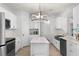 Spacious, modern kitchen featuring white cabinets, stainless appliances, and a kitchen island at 209 Villa Di Este Ter # 205, Lake Mary, FL 32746