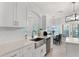 Bright, all-white kitchen featuring stainless steel appliances and a kitchen island at 209 Villa Di Este Ter # 205, Lake Mary, FL 32746