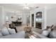 Bright, open-concept living room featuring hardwood floors, a ceiling fan, and an adjacent dining area at 209 Villa Di Este Ter # 205, Lake Mary, FL 32746