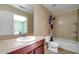 Bathroom with cherry vanity, tile floors and a shower-tub combination at 2120 Windsor Lake Cir, Sanford, FL 32773