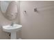 Powder room featuring a pedestal sink, oval mirror, and towel rack at 2120 Windsor Lake Cir, Sanford, FL 32773