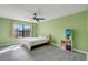 Sunlit bedroom featuring neutral window treatments and shelving for storage at 2120 Windsor Lake Cir, Sanford, FL 32773